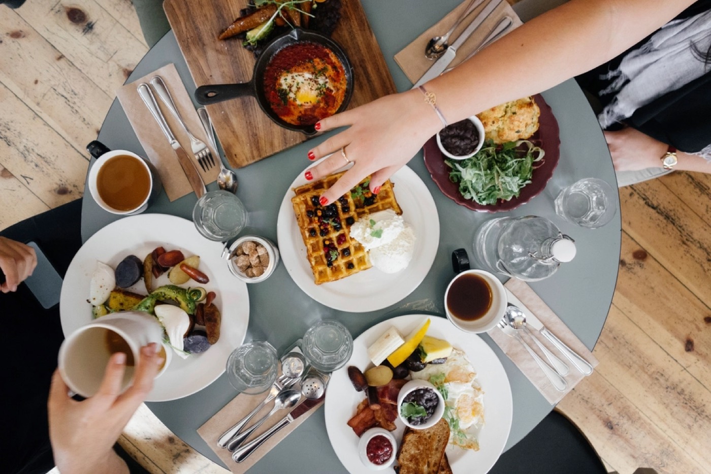 A restaurant brunch table with coffee and food